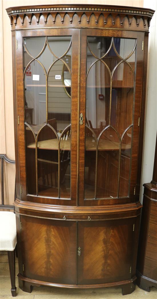 A George III style mahogany bow fronted standing corner cupboard, H.189cm